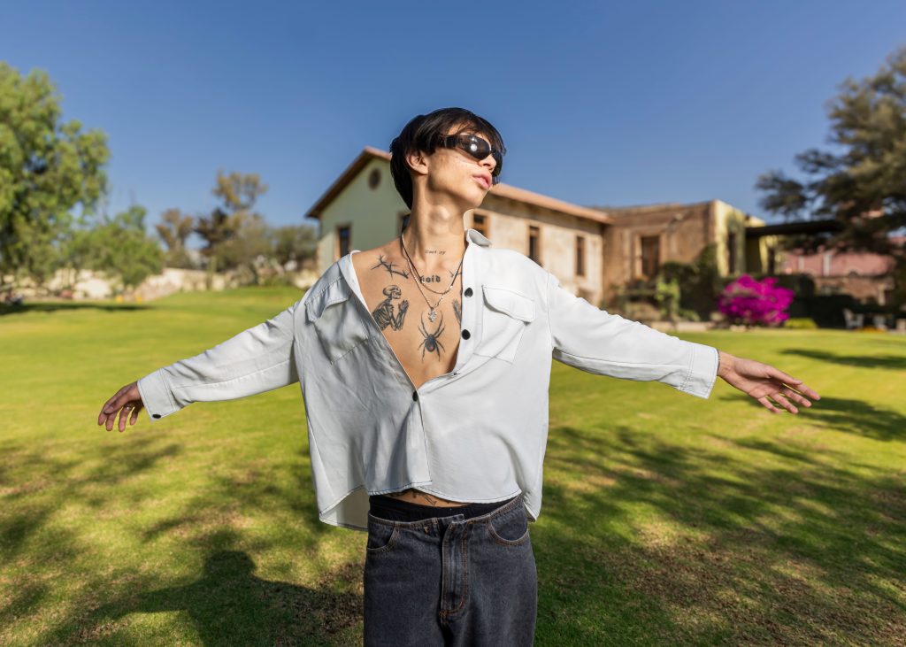 Trendy individual with tattoos enjoying sunny day in Ibarrilla, Guanajuato, Mexico.